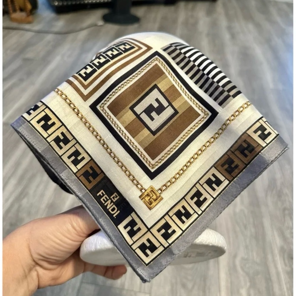 Fendi scarf with sticky tab. We just removed no damage. With hidden background